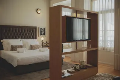 a bedroom with a bed with a flat screen tv at viterbo'8 - The Artists House in Porto