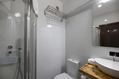 a white bathroom with a toilet and a sink at FLH Porto Spacious Apartment with Balcony in Porto