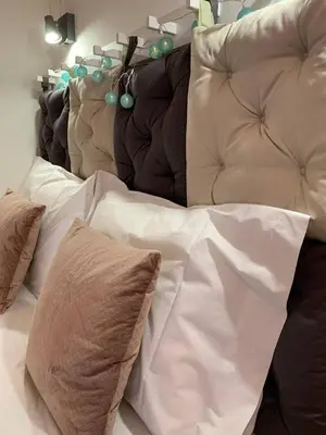 a bed with white sheets and pillows on it at SP199 Flat by in Porto