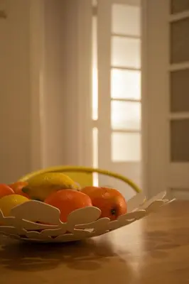 a bowl of fruit sitting on a table at North Star Flats @ Dom Luís I Bridge in Vila Nova de Gaia