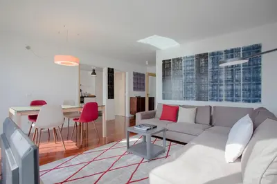a living room with a couch and a table at Liiiving in Porto | Bright Light Apartment in Porto