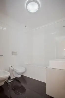 a bathroom with a sink and a tub and a toilet at Liiiving in Porto | Bright Light Apartment in Porto