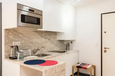 a kitchen with a counter with a sink and a microwave at Tito Studio Terrace in Porto