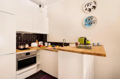 a kitchen with white cabinets and a counter top at Exquisite Retreat in a Traditional Area of Porto in Porto