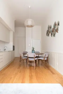 a kitchen and dining room with a table and chairs at Lit Apartments - SÁ DA BANDEIRA in Porto