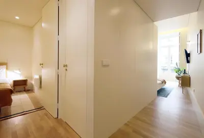 a room with white walls and a sliding door at HM - Ribeira São João 2E in Porto