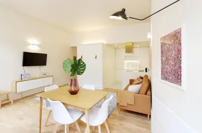 a living room with a table and chairs and a couch at HM - Ribeira São João 2E in Porto