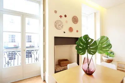 a dining room with a table with a plant on it at HM - Ribeira São João 2E in Porto