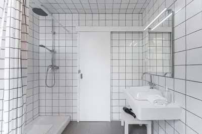 a white bathroom with a sink and a shower at GuestReady - Innvict Residences in Porto