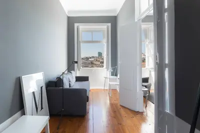 a living room with a couch and a window at GuestReady - Innvict Residences in Porto