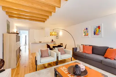 a living room with a couch and a table at Almada Luxurious Duplex by DA'HOME in Porto
