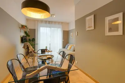 a living room with a glass table and chairs at DA'HOME - Marquês Lovely 2BD Apartment in Porto