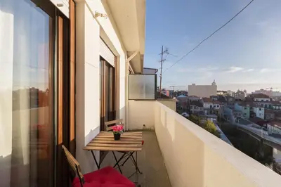 a balcony with a table and a view of a city at Cozy Apartment Alegria Balcony in Porto