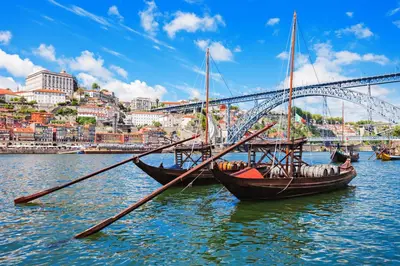 two boats in the water in front of a bridge at Cozy Apartment Alegria Balcony in Porto