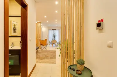 a bedroom with a bed and a hammock in a mirror at DA'HOME - Marquês Unique Terraza in Porto