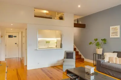 a living room with a couch and a table at DA'HOME - Vitoria Duplex Apartment in Porto