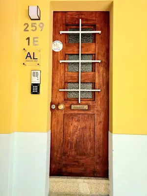 a wooden door in a building with a sign on it at Oporto Yellow Villas in Porto
