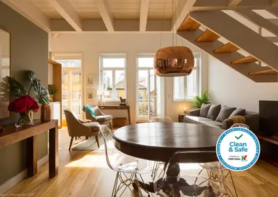 a living room with a table and a couch at Comercio RIBEIRA Luxury Penthouse Apartment in Porto