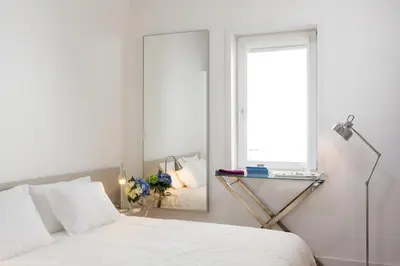 a bedroom with a bed with a mirror and a window at Comercio RIBEIRA Luxury Penthouse Apartment in Porto