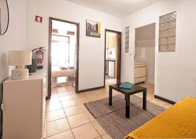 a living room with a couch and a table at Ribeira Vintage Suite in Porto