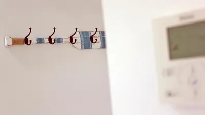 a row of glasses hanging on a wall at São João Oporto Residence I & II in Porto