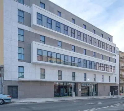 an office building on the corner of a street at NH Porto Jardim in Porto