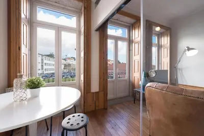 a room with a table and some windows at Fontainhas Design Apartment by DA'HOME in Porto