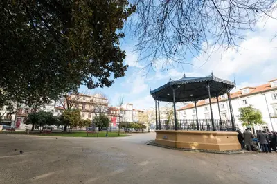 a group of people standing around a gazebo in a park at Fontainhas Design Apartment by DA'HOME in Porto