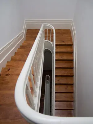 a spiral staircase in a room with wooden floors at O da Joana in Porto