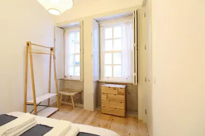 a white bathroom with a sink and a toilet at Host Wise - UNIK Porto Apartment in Porto