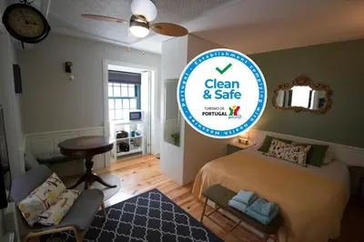 a bedroom with a bed and a sign that says clean and safe at Oporto Histórico - Bonjardim in Porto