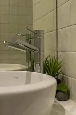 a bathroom sink with a faucet on a counter at Oporto Histórico - Bonjardim in Porto