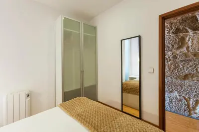 a bedroom with a mirror and a bed at Go2oporto - Ribeira do Porto in Porto