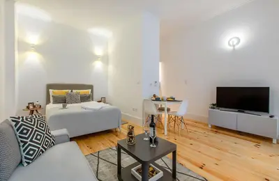 a living room with a couch and a table at Santa Catarina Experience in Porto in Porto