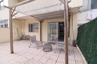 a patio with two chairs and a table on it at Gaia Central Apartment in Vila Nova de Gaia
