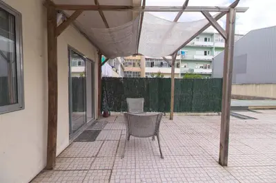 a patio with two chairs and a net at Gaia Central Apartment in Vila Nova de Gaia