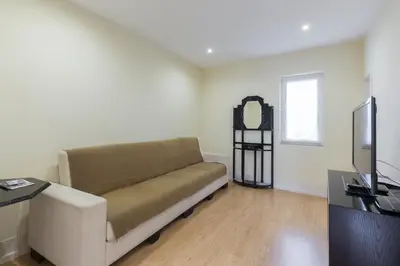 a living room with a couch and a television at Porto Belomonte Flats - T2 in Porto