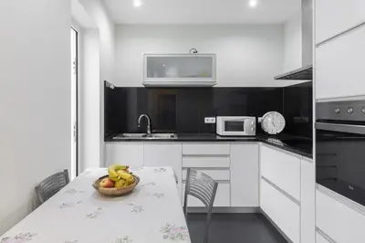 a kitchen with a table with a bowl of bananas on it at Porto Belomonte Flats - T2 in Porto