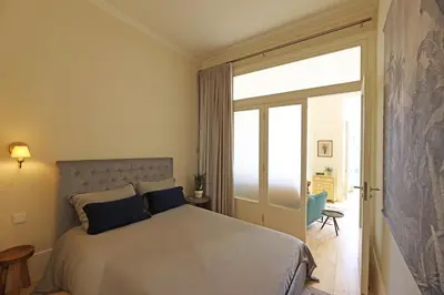 a bedroom with a bed and a sliding glass door at FLH Almada Cozy Apartment with View in Porto