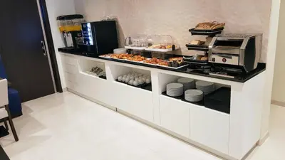 a kitchen with a counter with food on it at Porto City Hotel in Porto