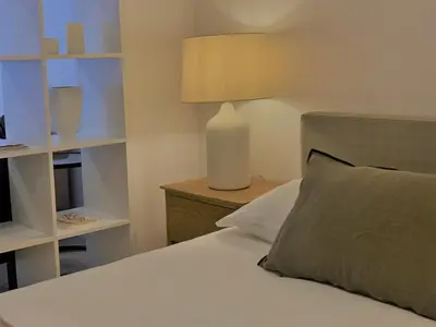 a bedroom with a bed and a lamp on a night stand at RIBEIRA CHARMING APARTMENTS in Porto