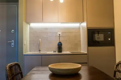 a kitchen with a table with a bowl on top of it at Olive Nature – Tourism Apartments in Porto