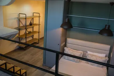 a room with a balcony with a couch and two lamps at Olive Nature – Tourism Apartments in Porto