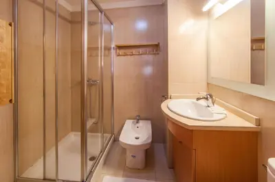 a bathroom with a shower and a sink and a toilet at Studios Porto Solar in Porto