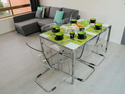 a table with chairs and cups on it in a living room at CM VINTAGE Apartments - Breiner in Porto