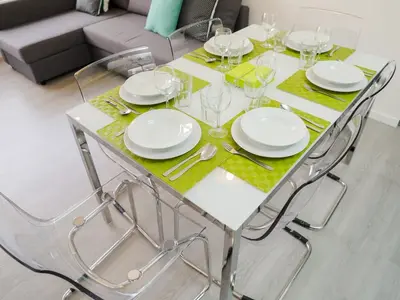 a white dining table with plates and glasses on it at CM VINTAGE Apartments - Breiner in Porto