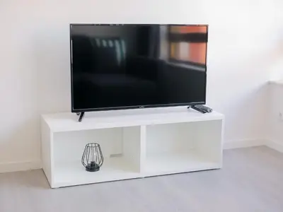 a white entertainment center with a flat screen tv on it at CM VINTAGE Apartments - Breiner in Porto