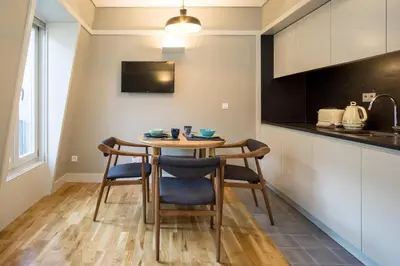 a kitchen with a table and chairs in a room at Porto Republica Apartments in Porto