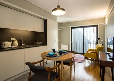 a kitchen and living room with a table and chairs at Porto Republica Apartments in Porto