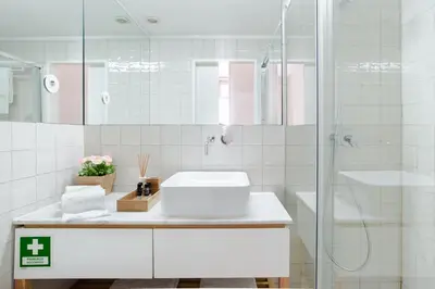 a white bathroom with a sink and a shower at Get a Golden and Flower Flat in Porto